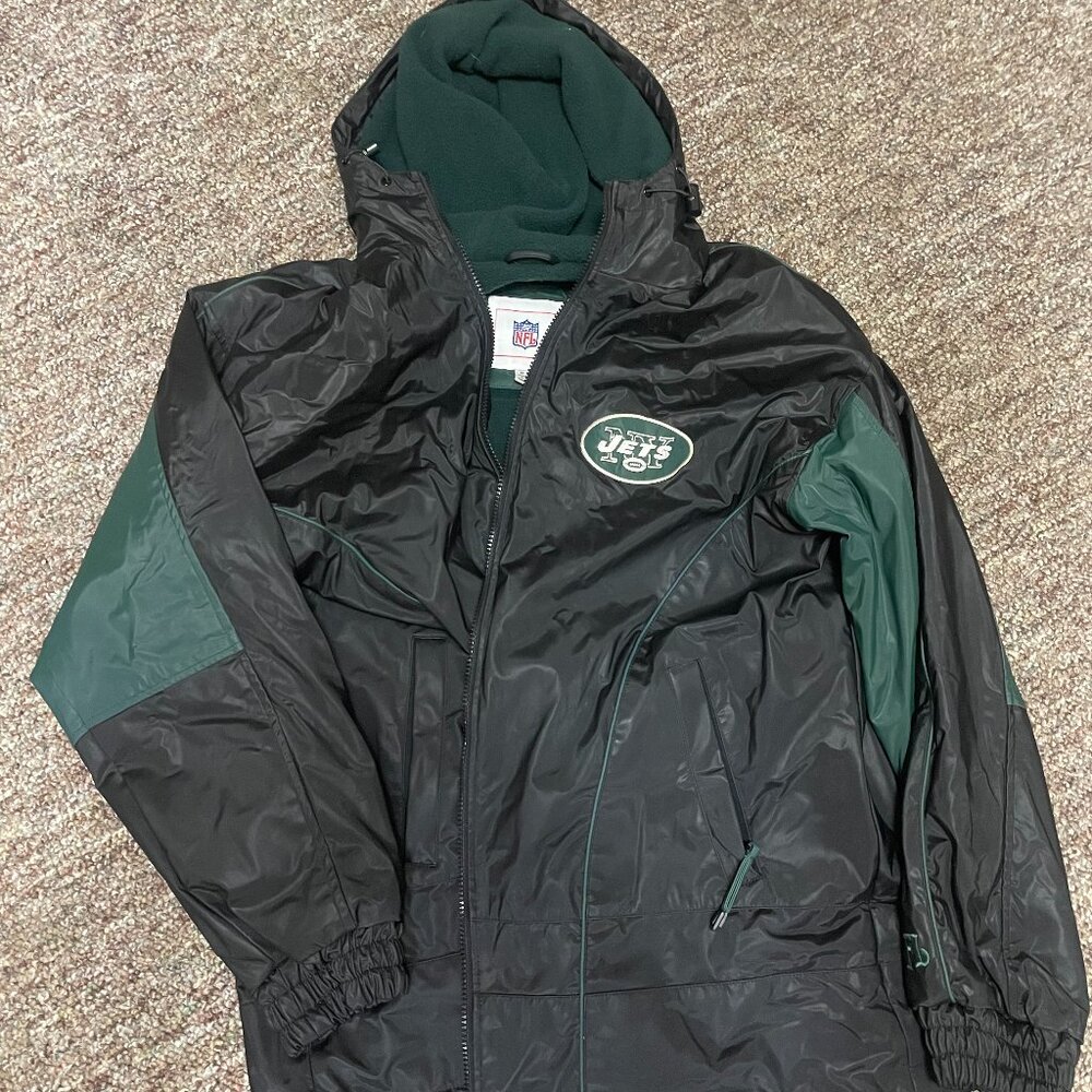 NY Jets NFL jacket in size medium. Black and green windbreaker style with hood